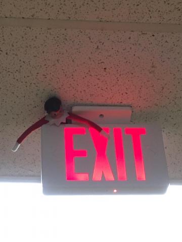 Elf hiding on EXIT sign