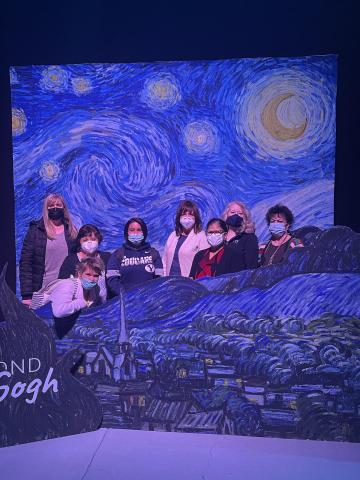 Legacy staff posing in Starry Night photo booth