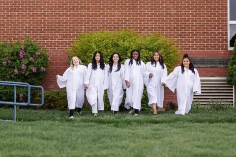 Girls in graduation robes walking