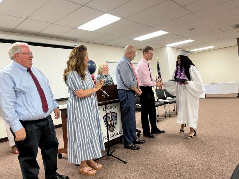 Nebo Board of Education shaking hand of Legacy graduate