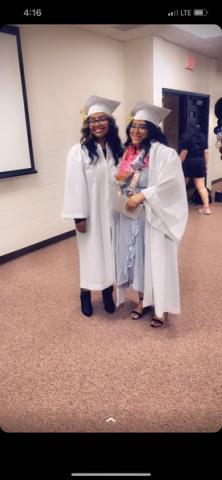 Two Legacy students in graduation robes