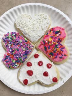Heart shaped sugar cookies with frosting and sprinkles