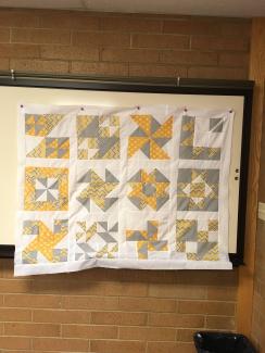 yellow and gray quilt blocks with white borders